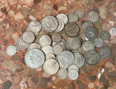 a pile of coins on the ground on the floor