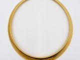 a gold necklace on a white background