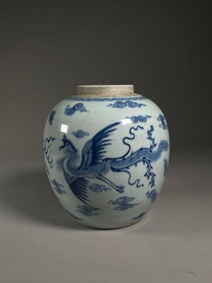 a blue and white vase with a bird on it