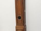a tall wooden grandfather clock next to a small clock