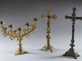 three metal candlesticks with a cross on top and a cross on the bottom