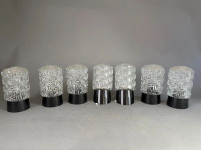 six clear glass tumbles lined up in a row on a table