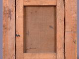 an old wooden frame with a rope hanging from it ' s side