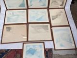 many pictures of a mountain are displayed on a table