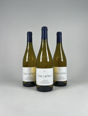 three bottles of wine sitting on top of a white table