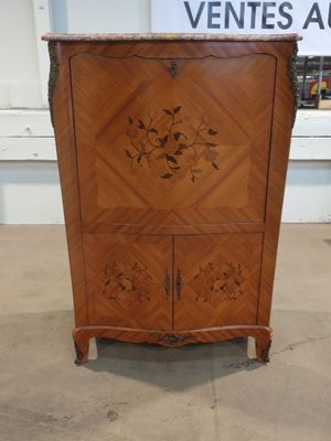a wooden cabinet with a carved design on it