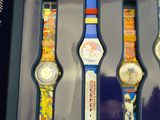 five watches in a display case with different designs on them