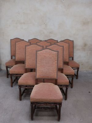 six chairs with upholstered backs and upholstered backs are lined up against a wall