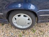 a close up of a car ' s tire on a gravel road