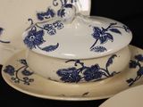 a blue and white plate with a bowl and a plate with a lid