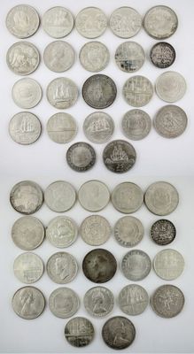 a pile of silver coins sitting on top of a white surface