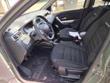 the interior of a small car with black seats and a steering wheel