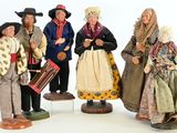 five figurines of people dressed in traditional clothing
