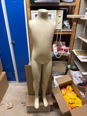 un mannequin dans une boîte en carton au milieu d'une pièce