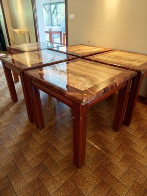 two tables that are sitting on the floor in the room