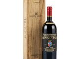the bottle of red wine is next to a wooden box