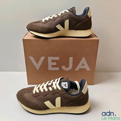 a pair of veja shoes in brown and white with a box