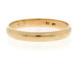 a close up of a gold ring on a white background