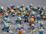 a lot of smurfs figurines on the table