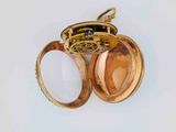 a gold locke with a magnifying glass inside of it