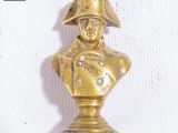 a gold statue of a man with a hat on