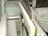 a machine that is cutting a piece of wood