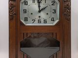 a clock that is sitting on a shelf in a room