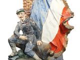 statue of two men sitting on top of a statue of a castle
