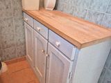 a bathroom with a toilet, sink, and cabinets in it