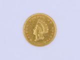 a close up of a gold coin on a white surface