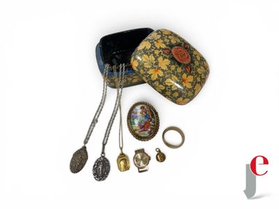 a hat, necklace, ring, and other jewelry on a white surface