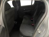 the back seat of a car with the door open and a seat belt down