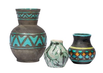 three vases sitting next to each other on a white surface