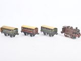 several toy trains are lined up in a row on a white surface