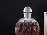 a bottle of liquor sitting on a table next to a box of cigarettes