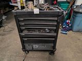 a black tool cabinet with tools on it in a garage