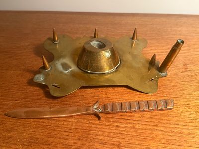 a knife and a knife holder sitting on a wooden table