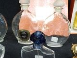 three bottles of perfume sitting next to each other on a table