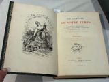 someone is holding a book open on a table with a drawing of a woman in a dress
