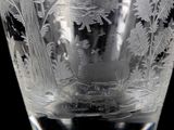 a glass vase with a picture of a deer in the woods