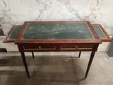 an old table with a marble top and two drawers on it
