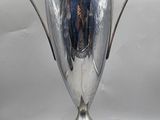 an image of a silver trophy sitting on top of a wooden base