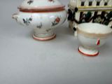 two small vases and a small bowl on a table