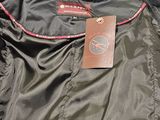 the back of a jacket with a tag on it sitting on a table