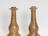 two vases that are sitting on a white surface