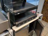 a pizza oven that is sitting on top of a counter