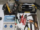 a table with tools and tools on it in a garage