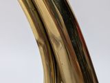 a close up of a brass plated table lamp with a curved arm