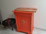 an orange cabinet in the corner of a room
