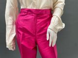 a close up of a mannequin wearing pink pants and a white shirt